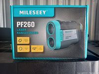 Front view of Mileseey PF260 box displaying the device image and highlighting built-in magnetic stripe, vibration alert, USB charging features.