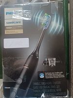 Front packaging of Philips Sonicare 9350 DiamondClean Smart showing the toothbrush handle, brush head, charging glass, and USB charging travel case with key features.