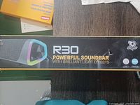 Photo of the Geo Soulion R30 soundbar box side with branding and product name highlighting the powerful soundbar with brilliant light effects.