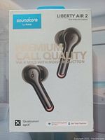 Front of retail box showing Soundcore Liberty Air 2 branding, image of earbuds, and features mention such as premium call quality, 4 microphones with noise reduction, Qualcomm aptX, diamond inspired drivers, and 28h total playtime.