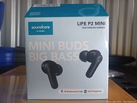 Photo of the unopened Soundcore Life P2 Mini True Wireless Earbuds retail box showing product name, branding and key features such as AI-enhanced calls and 32-hour playtime.