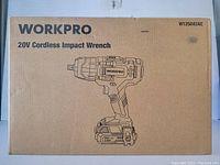 Photo showing original cardboard packaging of a Workpro 20V Cordless Impact Wrench with illustration of the tool on the front.