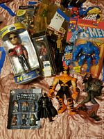 Mixed action figures including boxed and loose items from Marvel, NASCAR, and other collectibles