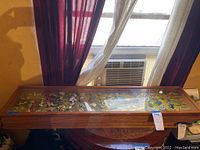 Wooden and glass display case exterior view showing overall lot