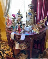 Full view of the crescent table with various decorative items on top.