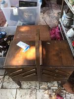 Closed wooden sewing box with extended compartments and handle, showing original wood finish with wear.