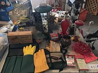 Overview photo showing garden gloves, bird feeders, bird food bag, bird netting, and garden tool belts.