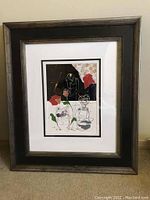 Full view of framed artwork leaning against wall