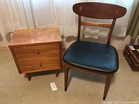 Frontal view of chair and side table together showing overall size and condition