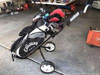 Full view of Callaway golf bag on Tartan golf cart, showing bag and wheel details