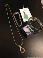 Full view of jewelry set showing all items: bangle, bracelets, chains, pendants and earrings