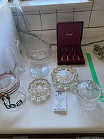 Full view of glassware items including bowl, vase, condiment bowls, sugar bowl, ashtrays, and glass storage jar with clamp lid labeled 'tea'.