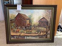 Frontal image of the original framed painting showing the net sheds and water with a small boat, wooden frame visible.