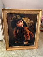 Full front view of oil painting of child with basket in gilt wood frame