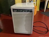 Front view of Classic D40 Frostguard dehumidifier showing vented front grill and black power cord on floor.