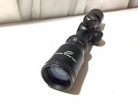 Front angled view of the black Excalibur Octane scope showing the lens and logo.