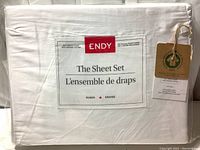 Image of folded bed sheet set in packaging labeled 'ENDY The Sheet Set Queen Grand 300 Thread Count 100% Organic Cotton' with GOTS certification tag.