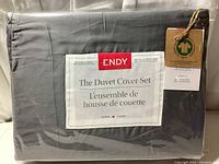 Photo showing folded storm gray duvet cover packaging with Endy label and size information