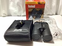 Binoculars with carrying case, strap, and original box displayed on white background