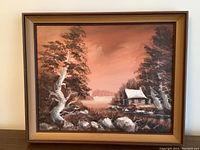 Full view of vintage oil painting signed Dalley depicting cabin and river scene in wooden frame