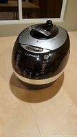 Front view of Cuchen rice cooker showing digital control panel and lid with vent and lock