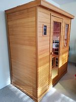 Exterior view showing cedar panels and glass door