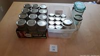 Overview photo of all Mason jars including boxed 32-ounce jars, bin of 4-ounce jars, and additional jars.