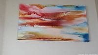 Abstract colorful oil painting with warm and cool hues mounted high on the wall