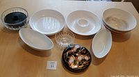 View of full set including porcelain platters, bowls, glass snack bowls, Japanese snack box, and tortilla serving box.