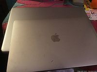 Closed Apple MacBook showing silver lid and Apple logo