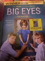 Photo of 'Big Eyes' DVD case featuring artwork with Amy Adams and Christoph Waltz, includes limited edition 32-page mini book.