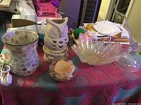Photo showing the full lot from above, including mosaic-patterned electric wax warmer, white owl figurine, translucent shell-shaped glass bowl, amber dish, clear rounded glass cup, and small glass mushroom figurine.