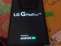 Tablet powered on showing LG G Pad 5 10.1 FHD splash screen with Android logo