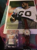 Printed photo of NFL player Casey Coleman numbered 60, smiling and holding a water bottle, showing upper body and face.