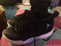 Side view of black Nike Jumpman Pro sneaker with white sole and Jumpman logo.