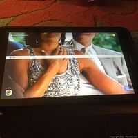 Samsung tablet with screen on displaying image and time 1:44, showing it powers on