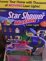 Photo of the Star Shower Motion Laser Light packaging showing product features and usage instructions.