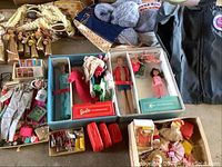 Photo showing boxed Barbie and Ken dolls, crafting kits, and various accessories including clothes and shoes