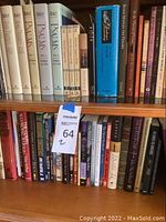 Photo of two wooden shelves filled with religious books including multiple volumes of Psalms and Bible studies.