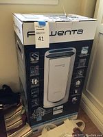 Front view of the large Rowenta air purifier box showing key features and image of the unit.