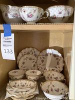 View of china pieces arranged on shelf showing three top items and six bottom items