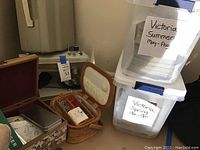 Photo showing the Kenmore sewing machine, part of sewing baskets, and plastic bins of crafting magazines