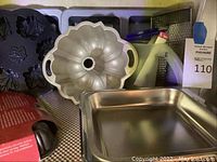 Photo showing leaf-shaped silicone mold, gold tone Bundt pan with handles, and square baking pan
