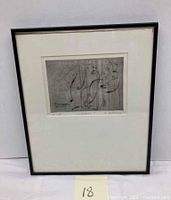 Framed etching with white mat and black frame against white background.