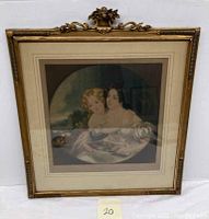 Front view of the framed mezzotint print showing the mother and daughter in formal dress. The frame is decorative and gold-colored with ornamental top.