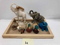 Group view of all animal ceramic figurines on wooden tray (not included)