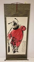 Full view of the vintage Japanese scroll painting featuring samurai warrior with patterned fabric borders.