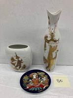 Wide shot showing all three items together on a white surface with lot number 85 visible