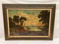 Framed vintage xerograph landscape painting featuring water, trees, and architectural detail.