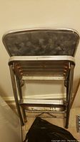 Image of Lincoln BeautyWare metal step stool showing non-slip surface and metal frame.